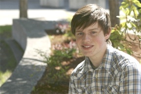 Quinn Ianniciello sits next to the garden project that he helped put together in the courtyard at South Whidbey High School.