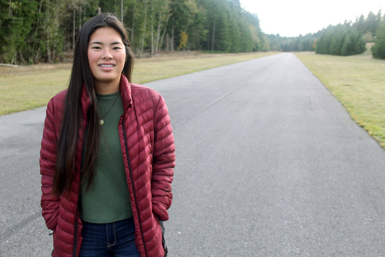 Photo by Kira Erickson / South Whidbey Record                                Arianna Marshall stands on the runway of Whidbey Airpark. One month ago, she raced along it to reach the site of a plane crash.