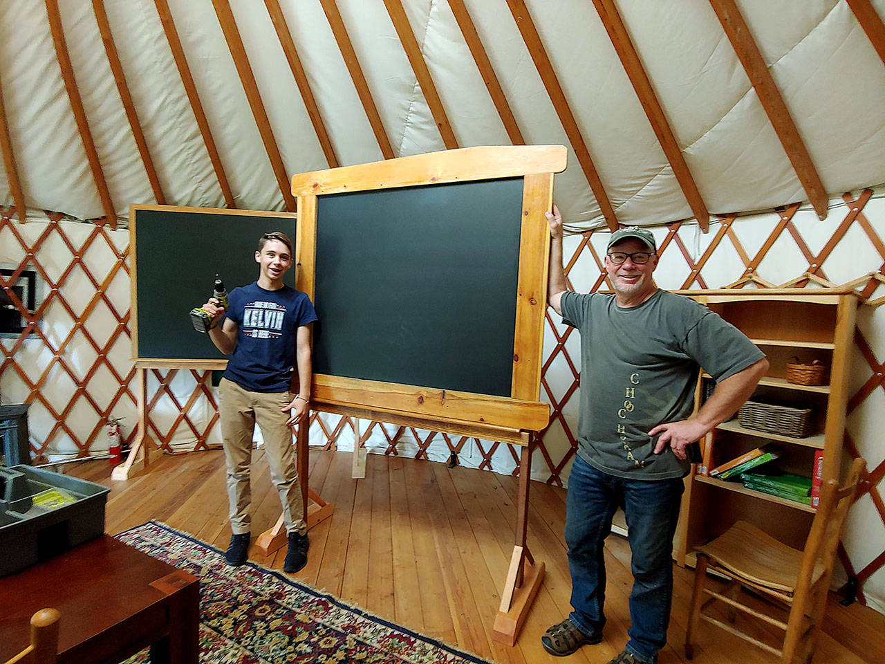 Photo courtesy of Marli Jenkins                                Woodhaven Faculty Liaison Kent Ratekin and freshman Kelvin Jenkins putting together a chalkboard at the Organic Farm School classroom.