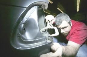Freddy Perez who is an auto body technician at Dee and Wiesje Baskerville's auto body business