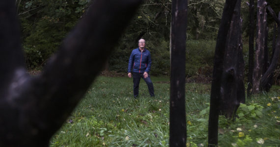 Earth Sanctuary owner Chuck Pettis next to his Ley Line piece on Tuesday, Oct. 20, 2020 in Langley, Wa. (Olivia Vanni / The Herald)