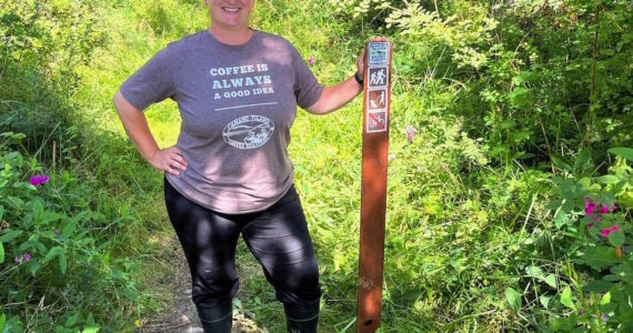 Photo by Harry Anderson
Whidbey Camano Land Trust Stewardship Director Jessica Larson stands before the new trailhead.