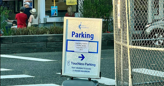 This Tuesday photo shows a sign by the Mukilteo waterfront parking lot that says the lot opens Sept. 2, however the lot’s opening has been delayed. (Andrea Brown / The Herald)