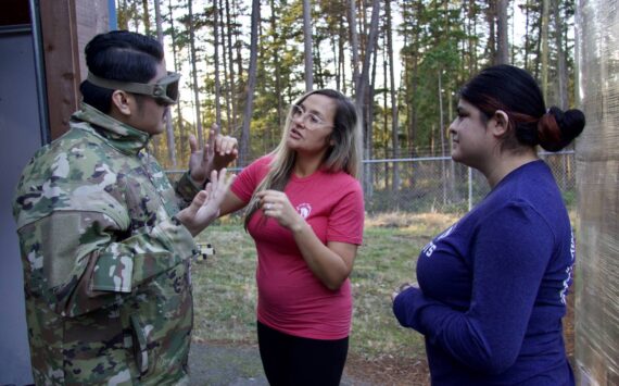 Photo by Rachel Rosen/Whidbey News-Times
Brittni Darbonnier and Julio Bucio show a pair of goggles to Justin Zafra.