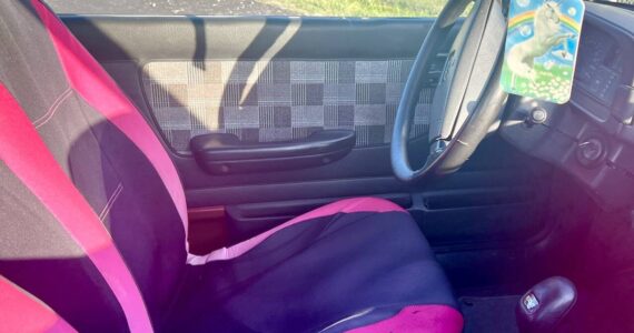The interior of the “Pork Chop Express". Owner Dave "Bronco" Erickson is seeking to re-home the car for $500, which includes the pictured unicorn air freshener. (Andrea Brown / The Herald)