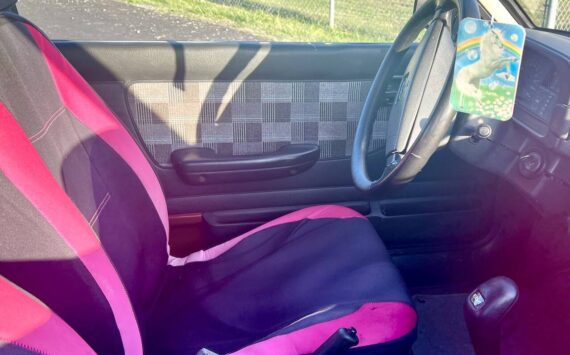 The interior of the “Pork Chop Express". Owner Dave "Bronco" Erickson is seeking to re-home the car for $500, which includes the pictured unicorn air freshener. (Andrea Brown / The Herald)