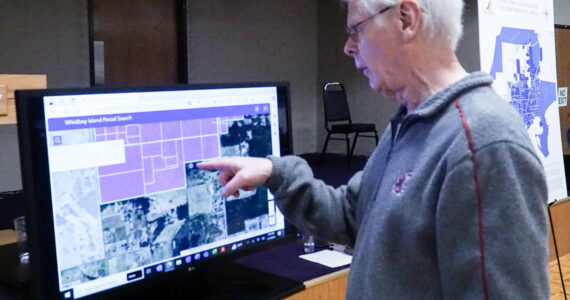 Oak Harbor resident Dennis Kjargaard points to his property at the PFAS public meeting on Thursday, which is 30 feet from the original PFAS sampling area. (Photo by Sam Fletcher)