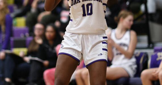 Caption – Oak Harbor’s Suki Warden takes a shot during a game against Burlington-Edison. The Wildcats are hosting a playoff game Thursday against Stanwood. Game time is 7 p.m. Photo by John Fisken.