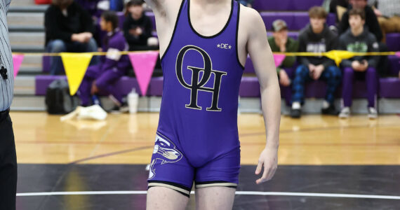 Oak Harbor’s Percie Hatfield has his hand raised in victory after a match during the regional tournament that took place Saturday at Oak Harbor High School. He placed first at 157 pounds and he will advance to the Mat Classic this weekend in Tacoma. Photo by John Fisken.