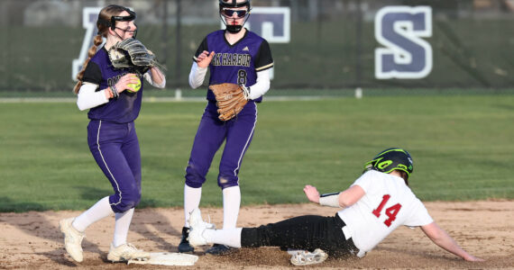 Photo by John Fisken
Shortstop Haylee Burleigh helps get a Cascade runner out during a game March 12 at Oak Harbor High School. Also helping is Mia Regan.