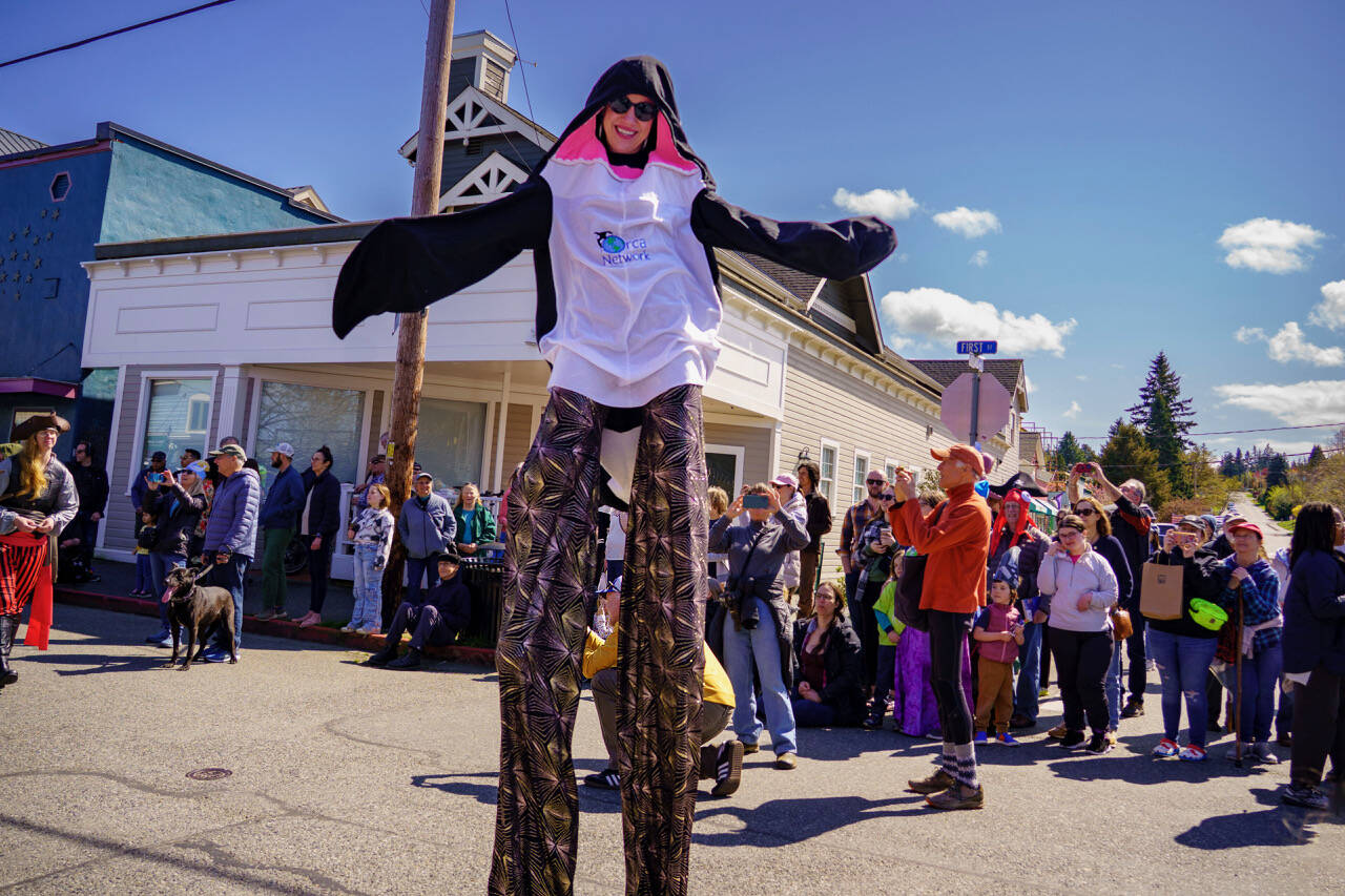 Lindsey Dewey of Clinton dressed up as a whale and walked on stilts as the Mutiny Bay Brass Band played upbeat music for the crowd. (Photo by David Welton)
