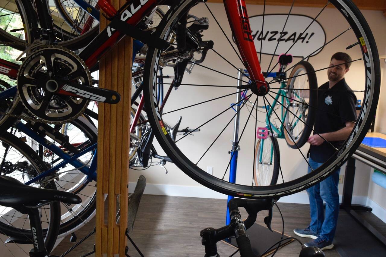 Photo by Patricia Guthrie
Trevor Stevens checks the wheel alignment on one of the dozens of renovated bicycles he fixes up for resale at his Coupeville store, Celerity Cycles, which opened last week.