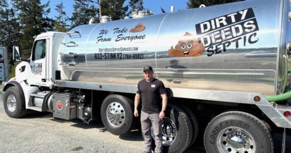 Photo by Harry Anderson
Keith Jordan stands beside his biggest septic pumping truck, which holds 5,000 gallon of stuff.