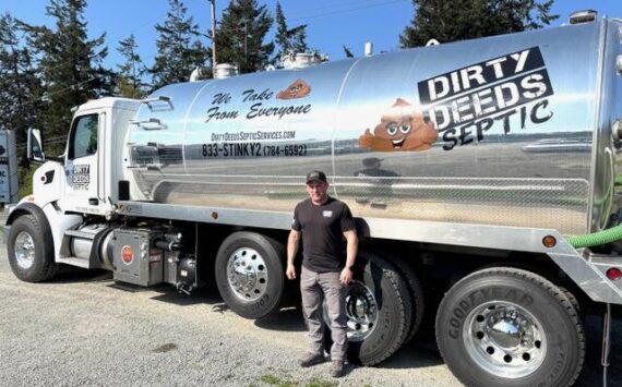 Photo by Harry Anderson
Keith Jordan stands beside his biggest septic pumping truck, which holds 5,000 gallon of stuff.