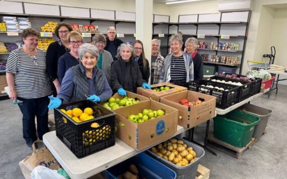 Volunteers at the new Gifts from the Heart food bank, including Coupeville Mayor Molly Hughes (back row, second from left), await their customers on opening day.