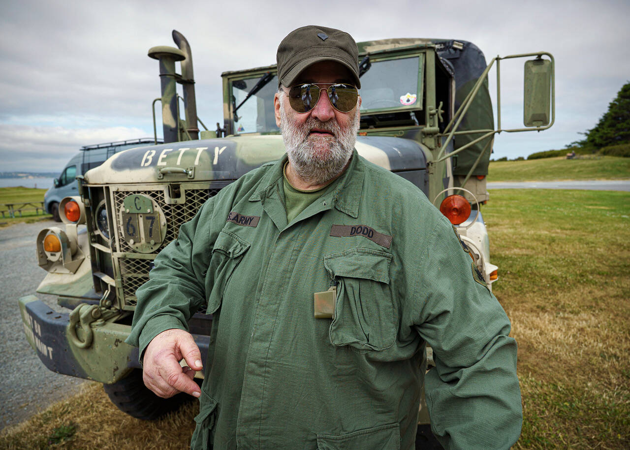 Bradley Dodd stands in front of his 1966 Kaiser Jeep M35 A2, originally meant for cargo and troop transport.