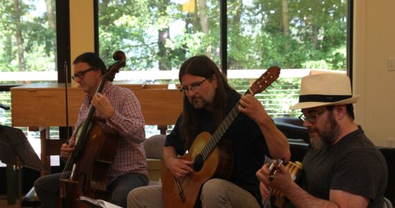 Photo by Allyson Ballard. Musicians play Ku'u Pua i Paoakalani written by Hawaiian Queen Lili'uokalani during her inprisonment. From right, Co-director Henry Lebedinsky on the 'ukelele, Kevin Cooper on the guitar, William Skeen on the cello.