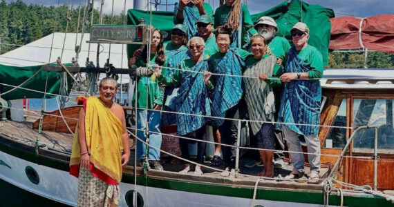 John Stone stands with Nā Hiku’s crew, dressed in traditional garb he was gifted for the “awa” ceremony.