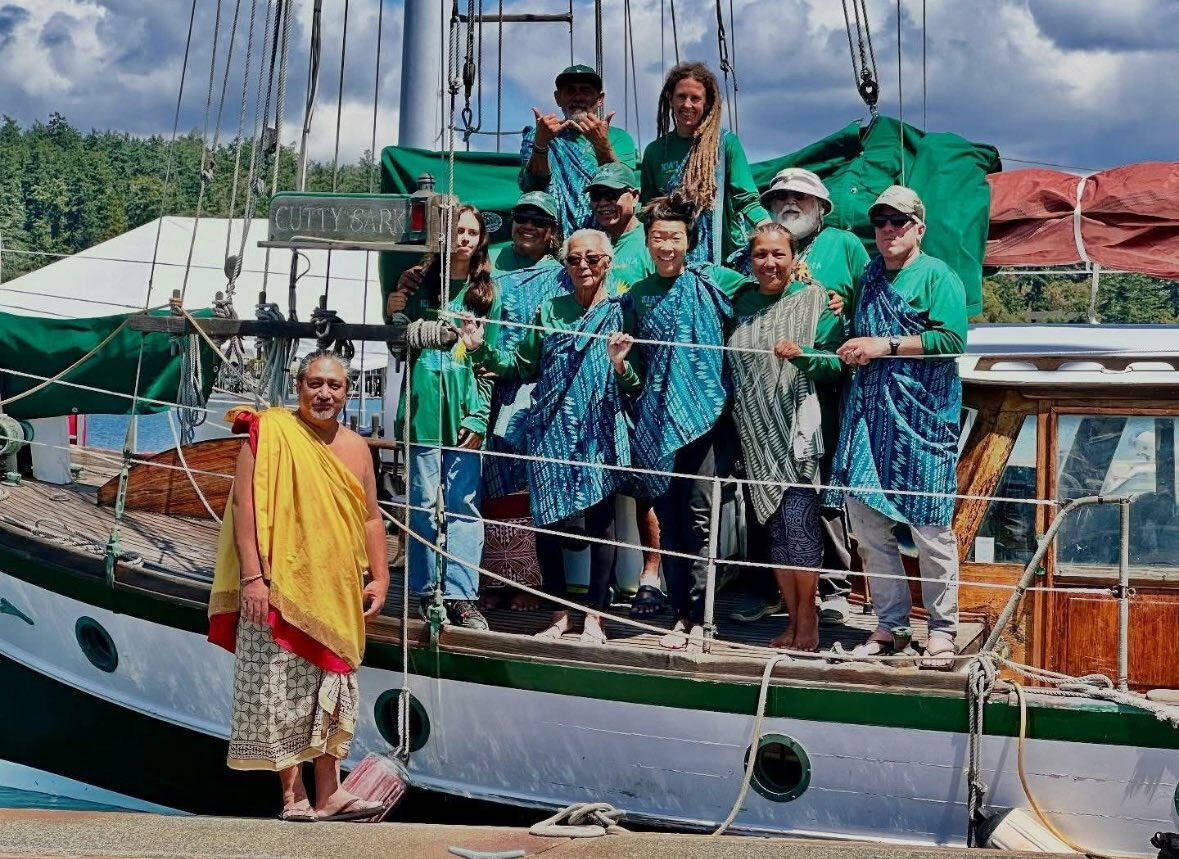 John Stone stands with Nā Hiku’s crew, dressed in traditional garb he was gifted for the “awa” ceremony (Photo provided)