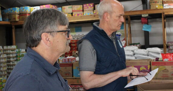 Shawn Durbin, the deputy director of North Whidbey Help House, shows U.S. Rep Rick Larsen around the food bank (Photo by Allyson Ballard)