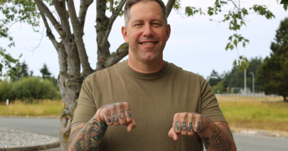 (Photo by Allyson Ballard) Command Master Chief Ben Faulise shows off his finger tattoos.