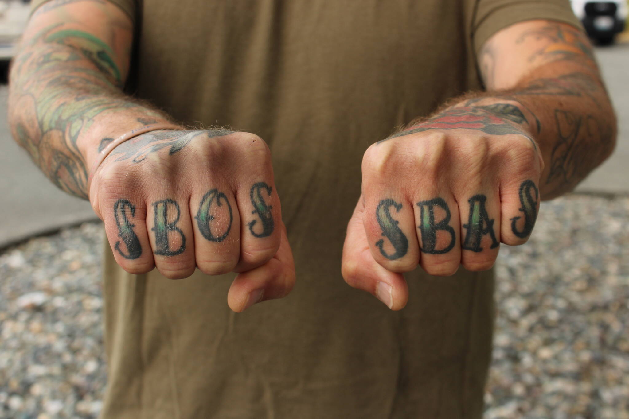 (Photo by Allyson Ballard) Faulise’s tattoos spell “SBOS” and “SBAS,” which stand for “Sailors Belong On Ships” and “Ships Belong At Sea.”