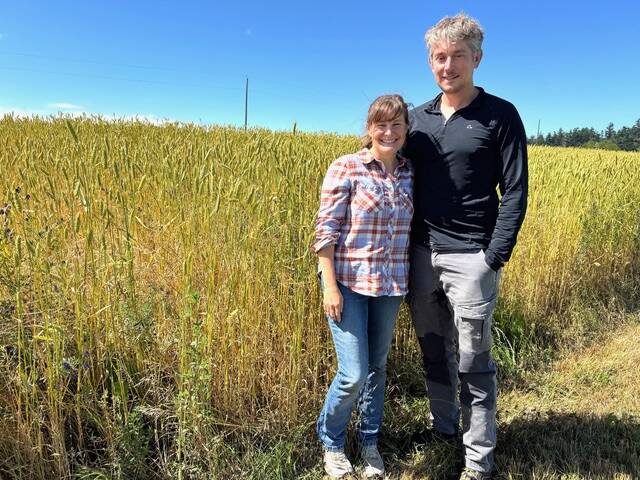 Danielle and Clark Bishop stand near a field of their Red Russian Wheat.