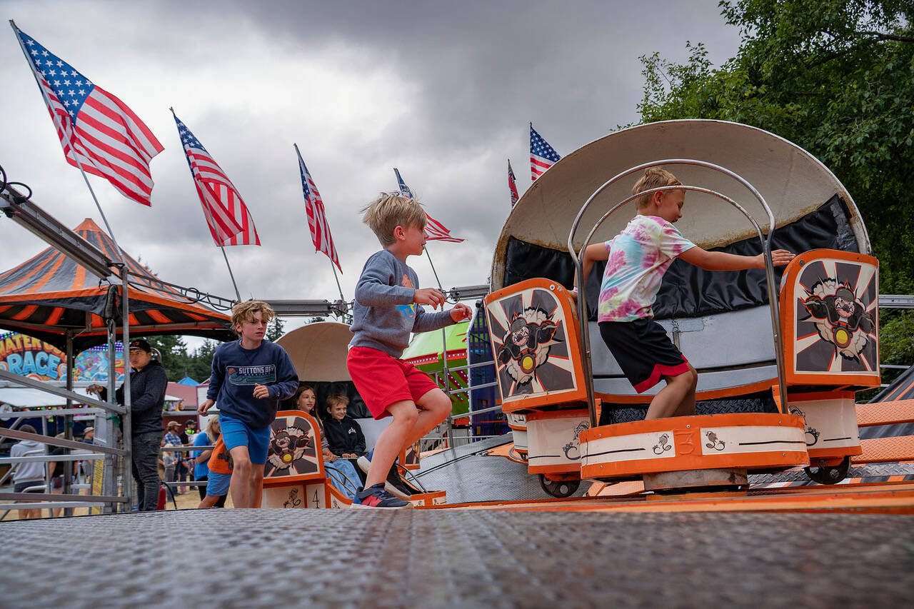 Kids run to the carnival rides.