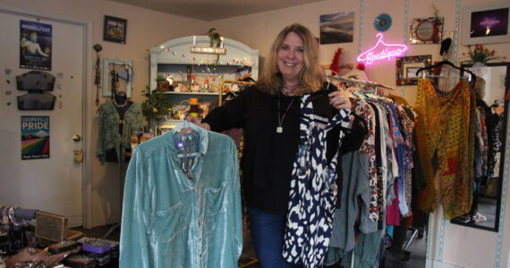 (Photo by Marina Blatt) Vicki Yount shows off the colorful clothing she sells in V-Boutique.