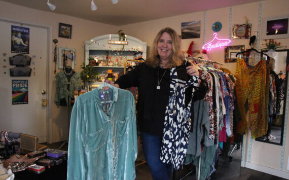(Photo by Marina Blatt) Vicki Yount shows off the colorful clothing she sells in V-Boutique.
