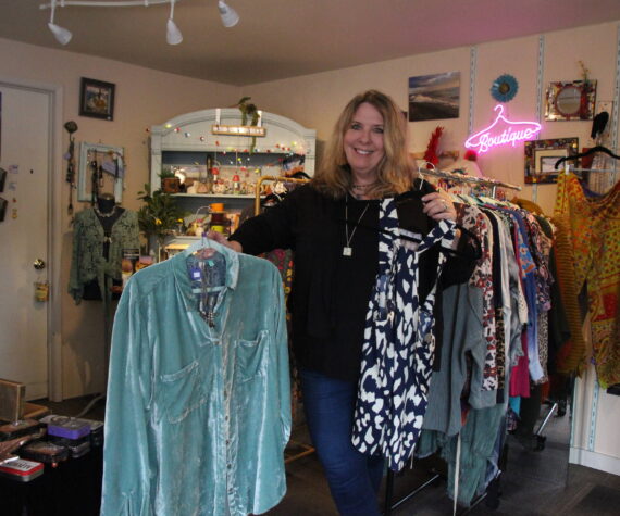 (Photo by Marina Blatt) Vicki Yount shows off the colorful clothing she sells in V-Boutique.