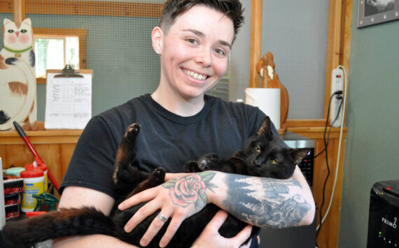 Animal care technician Morgan Kenaley with Shadow at the Freeland Cat Cottage. Photo by Mary Jo Adams.