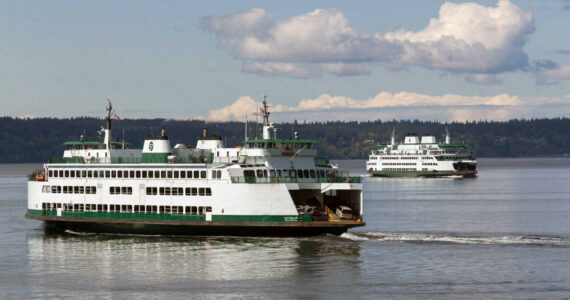 Ferries pass on a crossing between Mukilteo and Whidbey Island in August. (Andy Bronson / Herald file)
