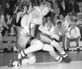 Freshman Falcon Jason Gilberts backs into his Blaine opponent Thursday night as he looks for a winning hold. He won his 189-pound match with a pin in the third round.