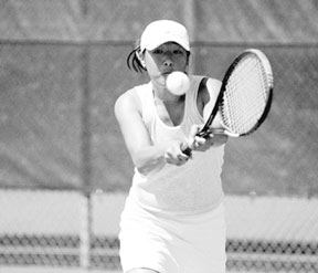 Jenny Saephan guns for the 2A doubles championship at the state tennis meet in May with partner Kylie Bozym. Saephan will return to the Falcon lineup next spring to either defend her championship or to cover new ground as a singles player.